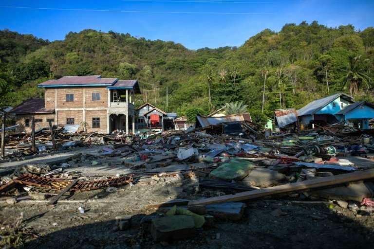 Damaged buildings are seen amid debris along a coastal area in Palu