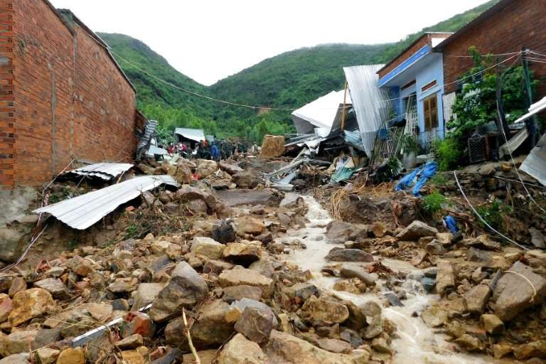 Damaged houses and debris were left by flash floods and landslides in the Phuoc Dong commune of central Vietnam's Khanh Hoa prov