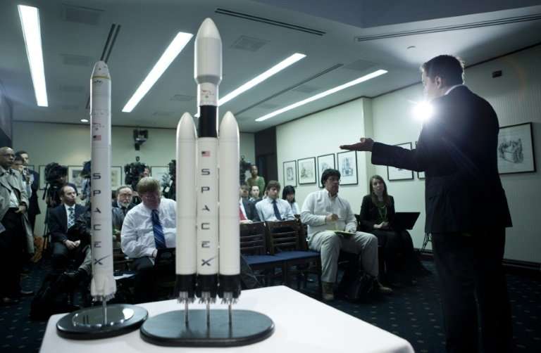 Elon Musk, CEO of Space X, shows off a mockup of the Falcon Heavy rocket, which is finally ready for its first launch