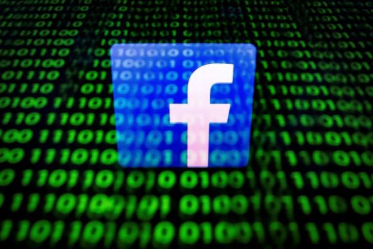(FILES) In this file photo taken on April 26, 2018 in Paris shows the logo of social network Facebook displayed on a screen and 