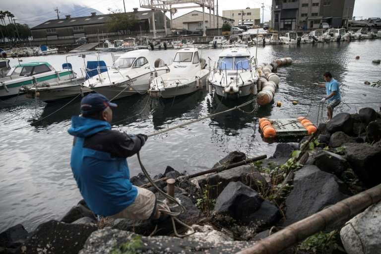 Fisherman made preparations for approaching Typhoon Tramiby by tying down their boats
