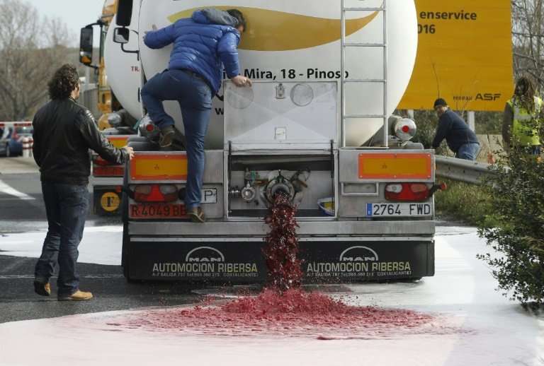 French winemakers emptying wine from a Spanish truck during a protest Le Boulon, ten kilometres forms the French-Spanish border,