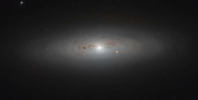 Hubble peers into a galaxy’s dusty haze