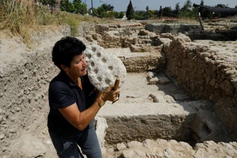 Israel Antiquities Authority archaeologist Alla Nagorsky carries a 1,600-year-old Mancala game from the Byzantine time found dur