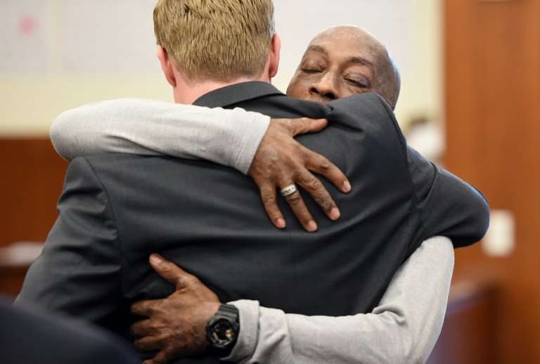 Johnson hugs one of his lawyers after hearing the verdict to his case against Monsanto at the Superior Court Of California