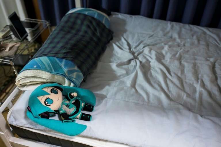 Kondo sleeps alongside a doll version of Miku, complete with a wedding ring