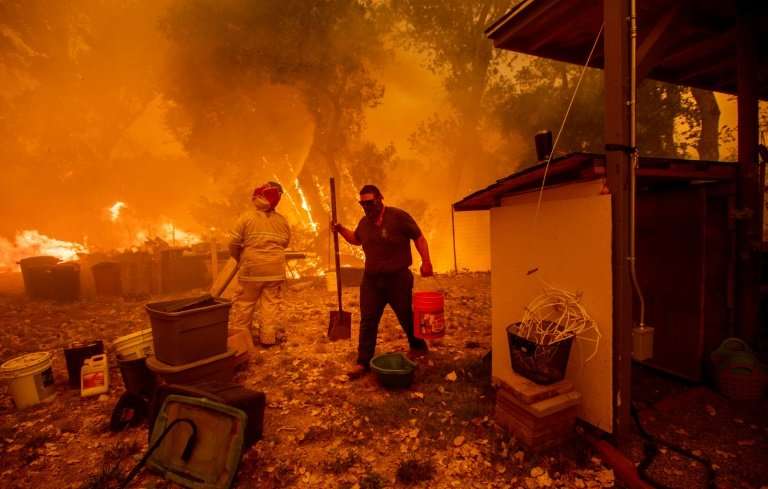 Lane Lawder tries to save his home near Clearlake Oaks, California, on August 4, 2018