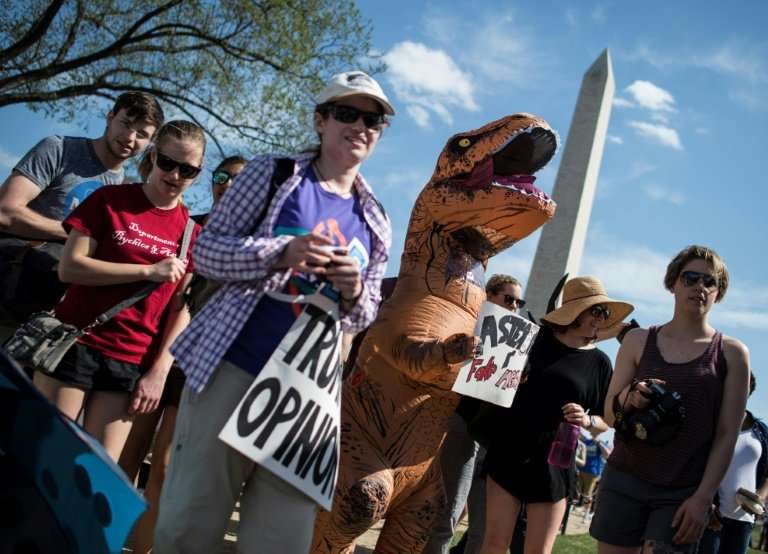 Many of the messages at the &quot;March for Science&quot; carried implicit criticism of Trump, who withdrew from the global Pari