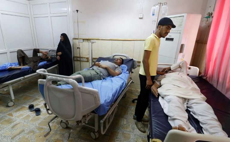 Men lie at a hospital in Basra in southern Iraq, on August 29, 2018, after falling ill from drinking polluted tap water