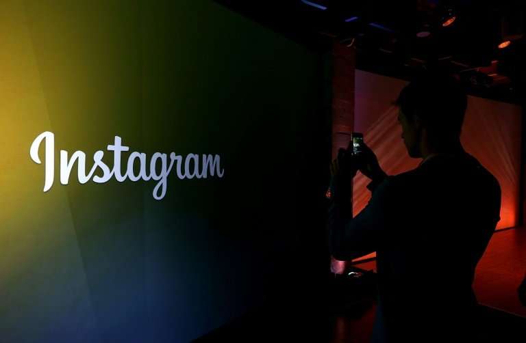 MENLO PARK, CA : An attendee takes a photo of the instagram logo during a press event at Facebook headquarters on June 20, 2013 