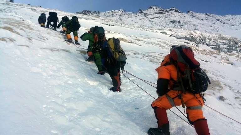 Mountaineers walk from Camp 3 to Camp 4 as they push for the summit of Mount Everest