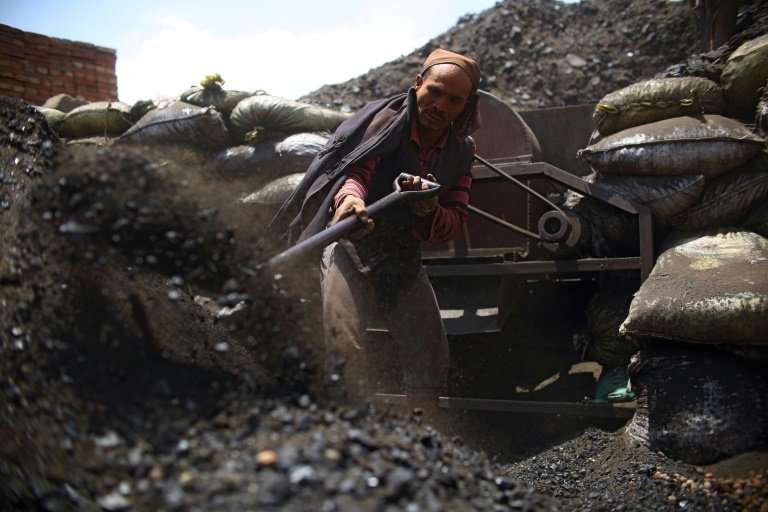 Nepali worker shovels coal at a brick factory in Bhaktapur, on the outskirts of Kathmandu. There are more than 200,000 kiln work