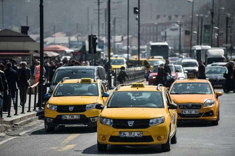 Official yellow taxis wait for customers in Istanbul where President Recep Tayyip Erdogan says rival ride-app Uber is &quot;fini
