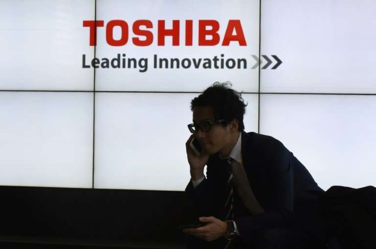 On hold: Toshiba says it is still waiting to hear whether regulators have approved of the sale of its chip unit
