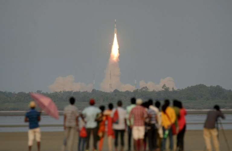 Onlookers watch as the  GSAT-6A communications satellite is launched
