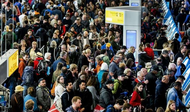 Passengers wait patiently after a power cut forced authorities to close Amsterdam's Schiphol Airport, one of Europe's busiest, f