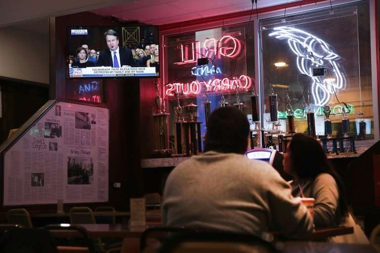 Patrons at a bar in Chicago watch the news on television during Supreme Court Justice Brett Kavanaugh's Senate confirmation hear