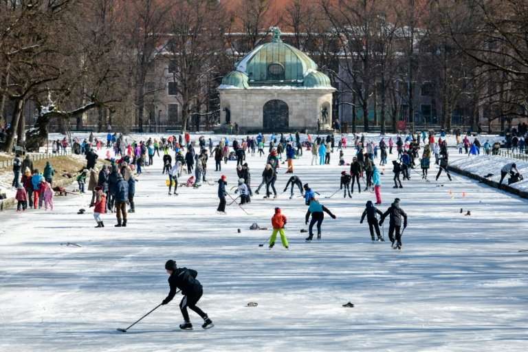 People play ice hockey on the frozen canal at Nymphenburg Palace in Munich, southern Germany on Sunday