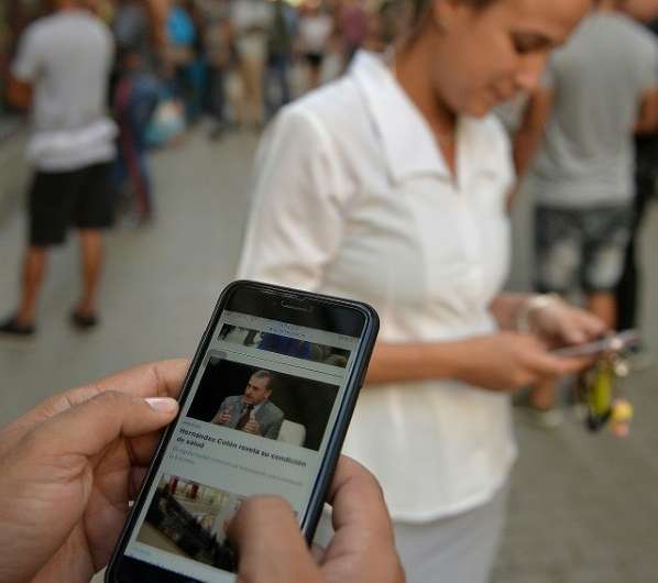 People use their mobile phone to connect to the internet in Havana