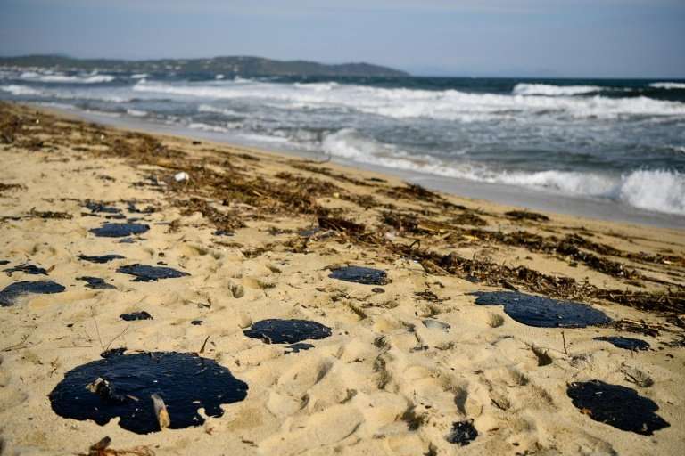 Pools of tar fester on the sand of Pampelone beach in Ramatuelle, in the Gulf of Saint-Tropez