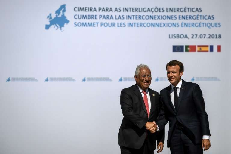 Portuguese Prime Minister Antonio Costa (L) greets French President Emmanuel Macron as he arrives for the Energy Interconnection