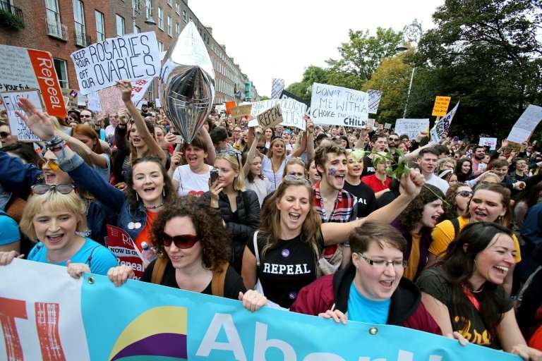 Protesters hold up placards as they take part in the March for Choice, calling for the legalising of abortion in Ireland after t