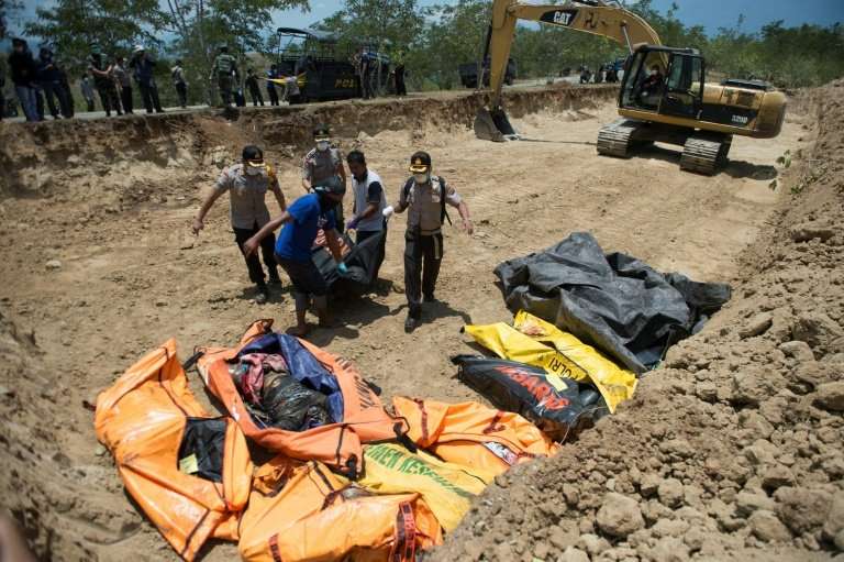 Rescue officials have been keen to bury victims in mass graves to stop the spread of disease