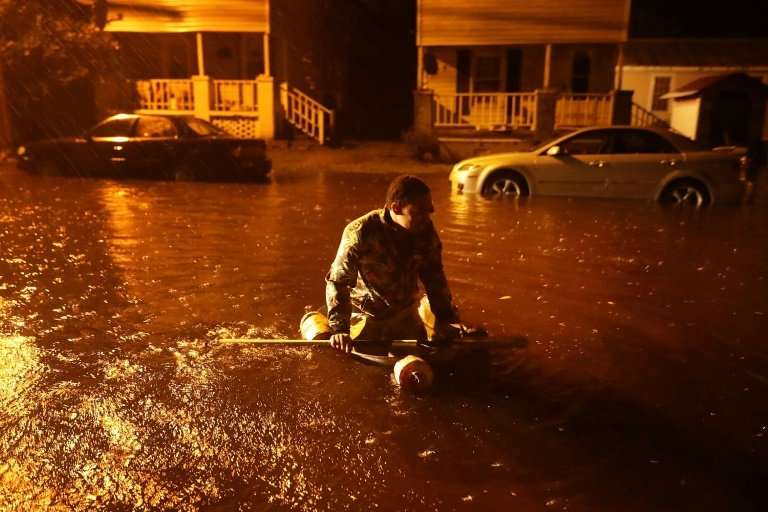 Resident Michael Nelson floats in a makeshift boat after the Neuse River flooded his street during Hurricane Florence in New Ber