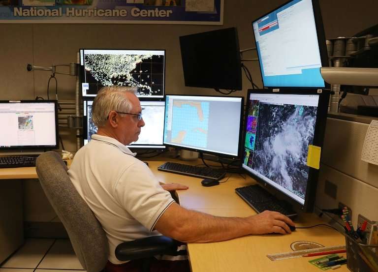Senior Hurricane specialist Stacy Stewart works at the National Hurricane Center to track the first tropical or subtropical depr