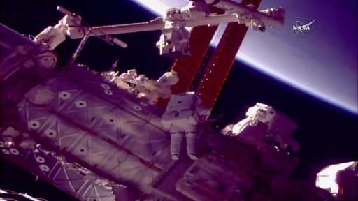 Spacewalking astronauts give new hand to robot arm
