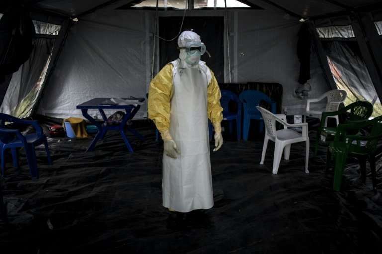 Suited up: A health worker gets ready to perform checks at an Ebola treatment centre in Beni