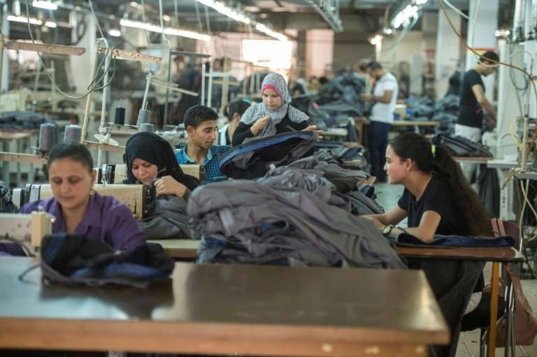 Tailors work at the Marie Louis factory, where long-fibre Egyptian cotton is used to produce high quality clothing for sale in F