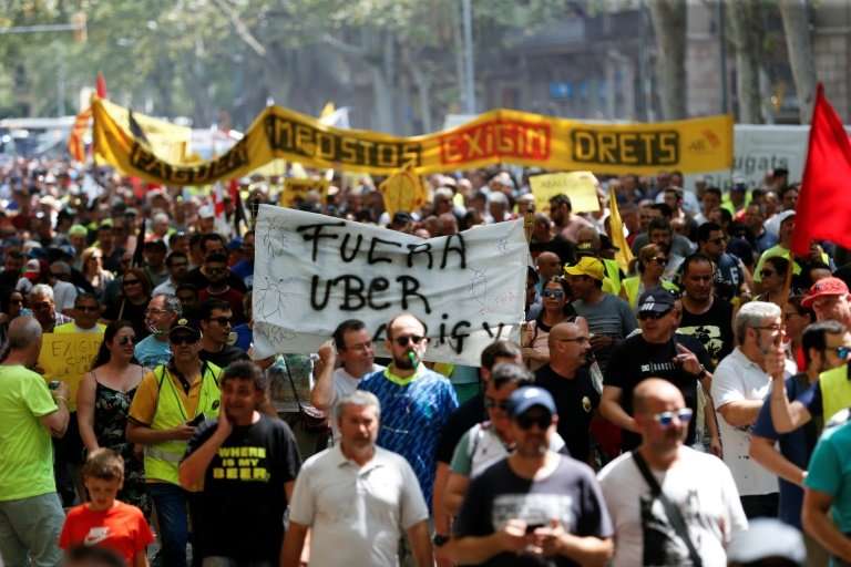 Taxi drivers march during a strike in Barcelona on July 25, 2018