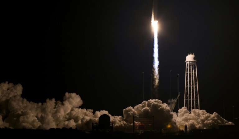 The 138-foot tall (42-meter) Antares rocket rises into the dark sky after blasting off from Wallops Island in Virginia