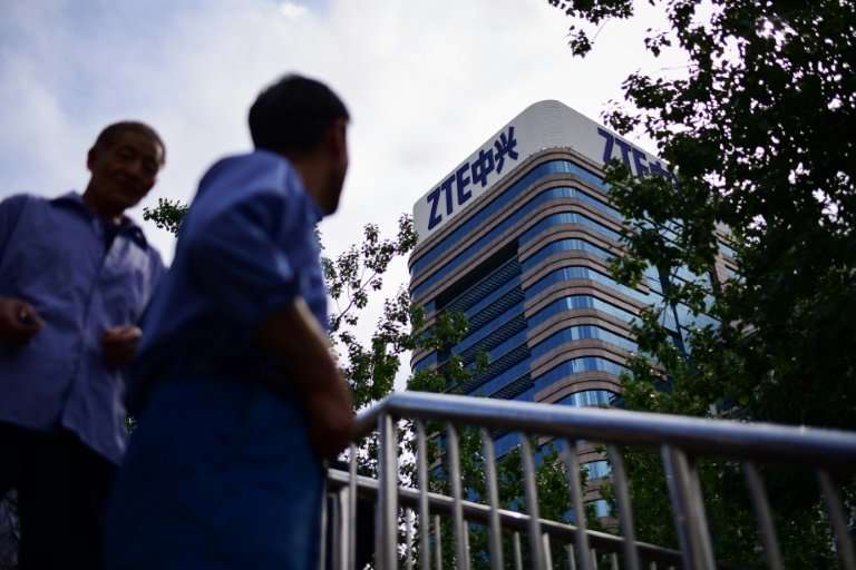 The deal with ZTE, whose logo is shown on a building in Beijing, comes as the US and China engage in separate and fraught trade 