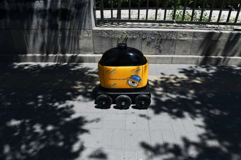 The yellow robots in Beijing's Kafka compound have little to trouble them, moving along a wide pavement with no obstacles—and no