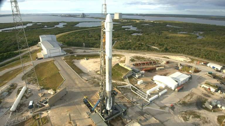 This December 2017 photo released by NASA shows a SpaceX Falcon 9 rocket with the Dragon spacecraft on Space Launch Complex 40 a
