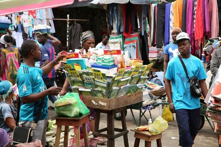This market stall on a Libreville street is piled high with rat poison, but some vendors readily sell kobolo under the table—a c