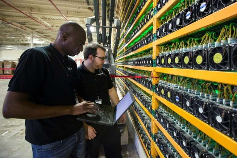 Two technicians look at bitcoin mining at Bitfarms in Saint Hyacinthe, Quebec