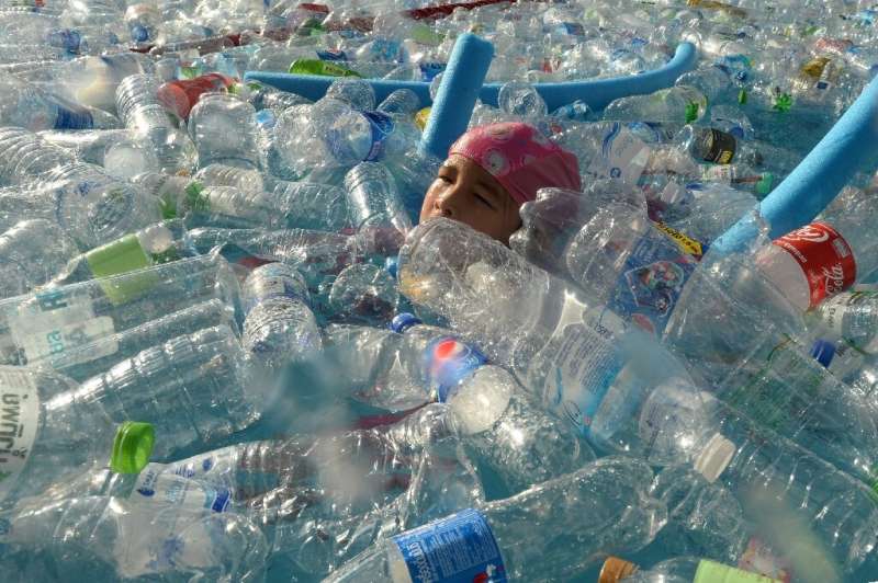 A child in Bangkok, Thailand swims in a pool  filled with plastic bottles during an awareness campaign to mark World Oceans Day 