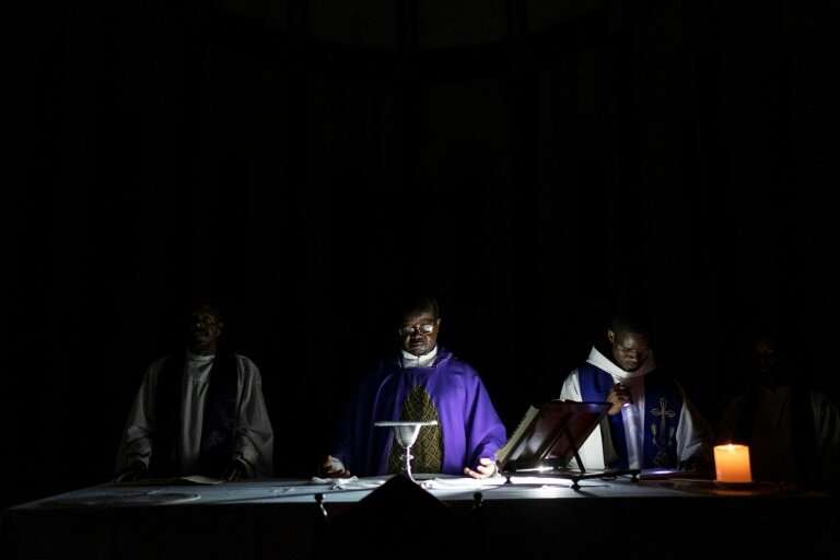 A priest prays during a service at the Ponta Gea Roman Catholic Cathedral