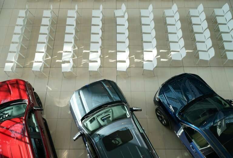 Cars are lined up ahead of the North American International Auto Show