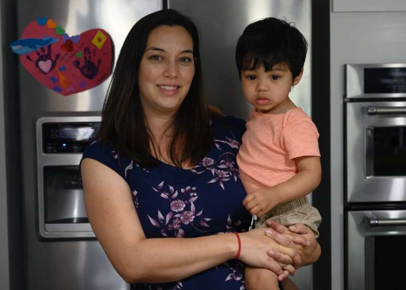 Cindy Luna holds her son Mateo, born via in-vitro fertilization in 2017, at the family's Virginia home