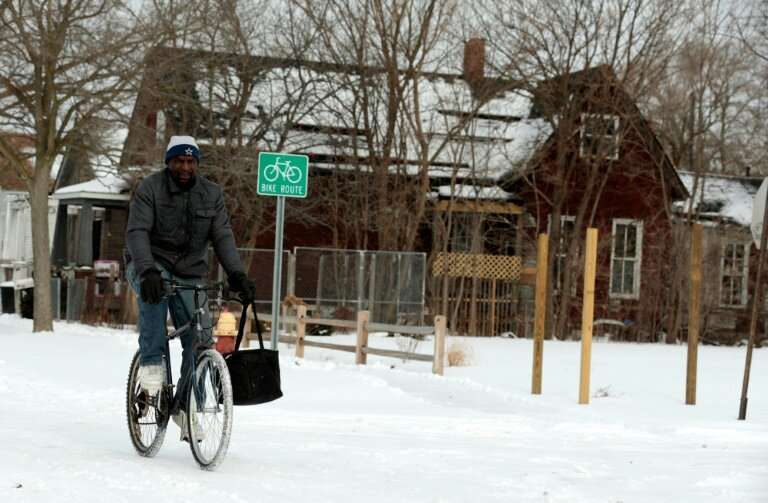 Jerry Jackson rides his bike in Detroit, Michigan—the state has declared a emergency in view of the frigid temperatures