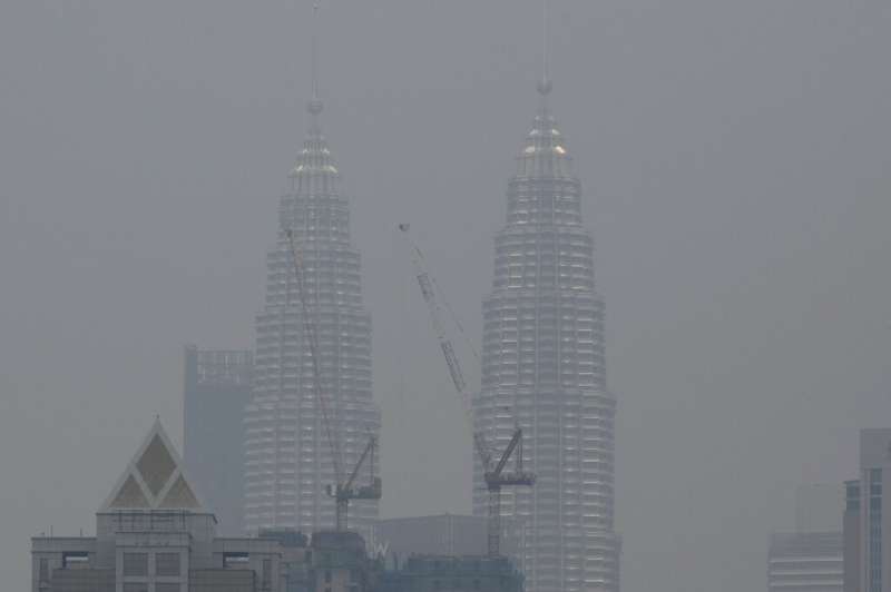 Malaysia's landmark Petronas Twin Towers are shrouded in haze in Kuala Lumpur as fires rage in Indonesia