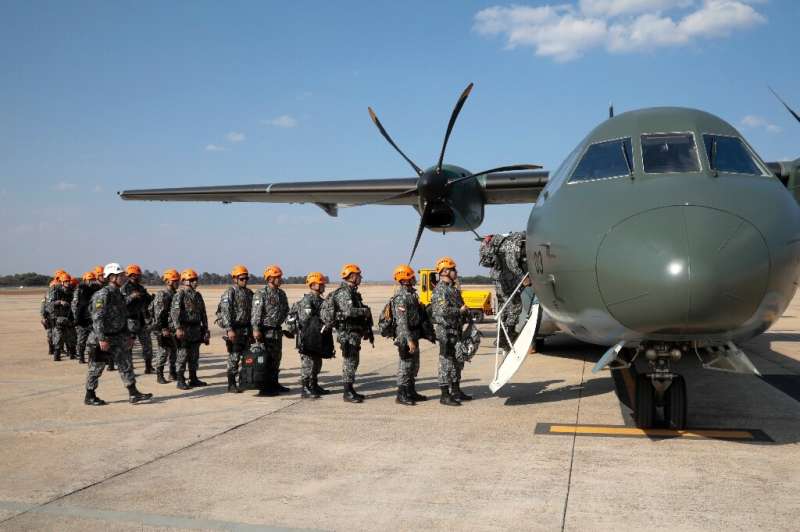 National Force military firefighters stand in line to board a plane to Rondonia northern Brazil, to help fight fires in the Amaz