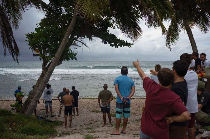 People gather at the coast hours before the Tropical Storm Dorian enters in Patillas, Puerto Rico on, August 28, 2019