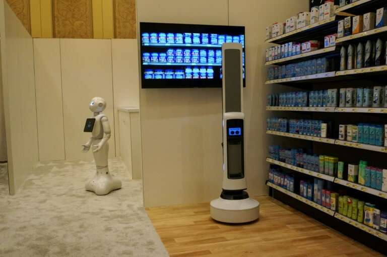 Pepper of SoftBank Robotics (L) and Tally of Simbe Robotics (R) are teaming up to work with retailers: Pepper interacts with cus