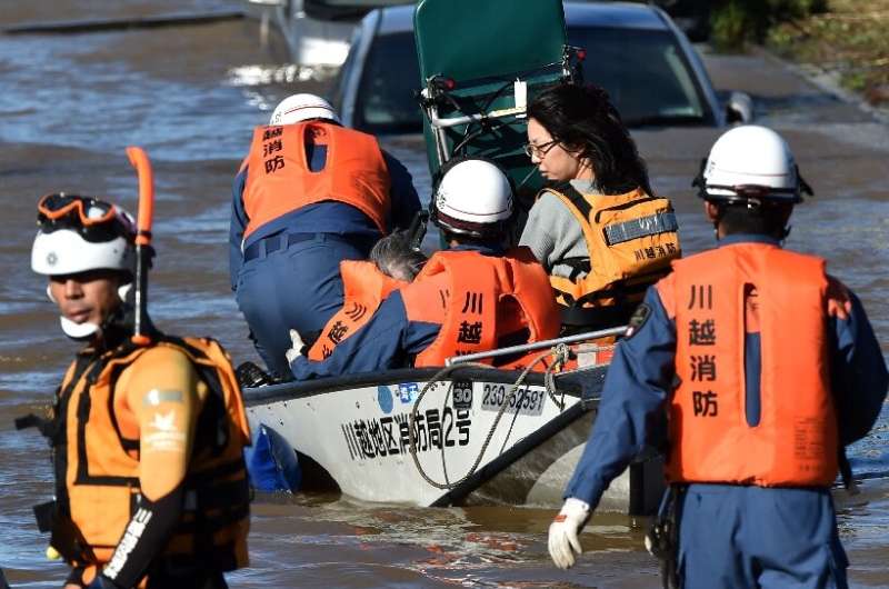 Rescue workers in Japan used boats and helicopters to reach people trapped after Typhoon Hagibis