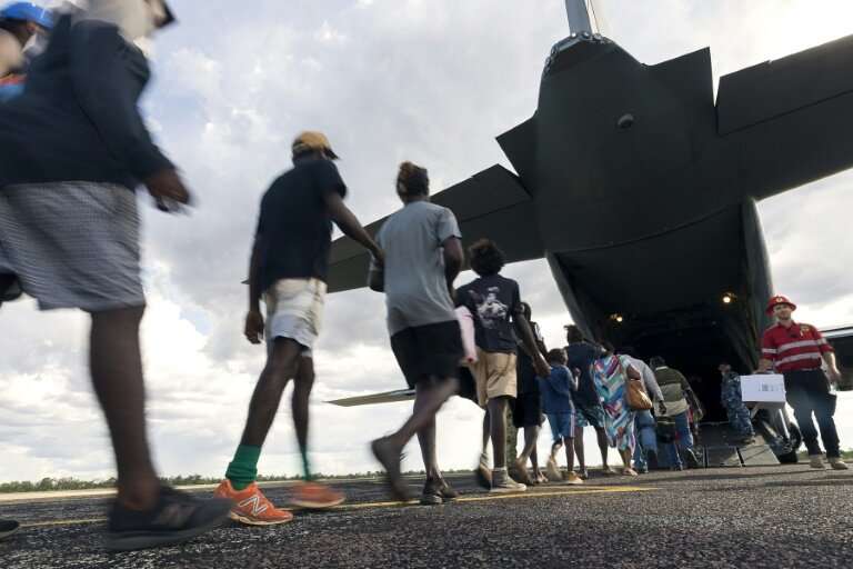 Residents of McArthur River, a remote town in the Northern Territory, boarding an Australian military plane as authorities evacu